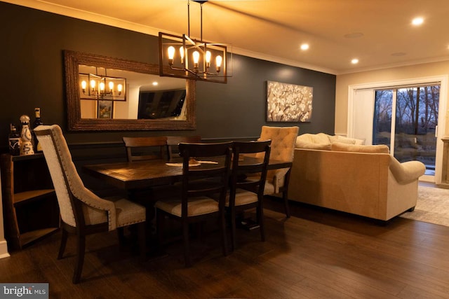 dining area with a notable chandelier, ornamental molding, wood finished floors, and recessed lighting