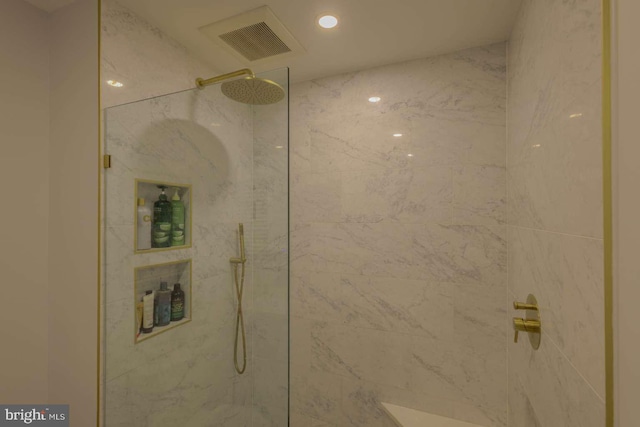 full bathroom with a marble finish shower, visible vents, and recessed lighting