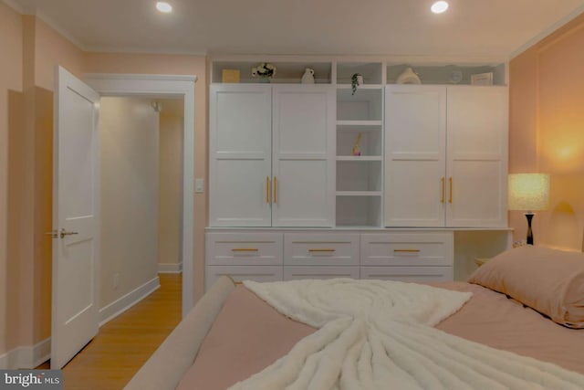 bedroom with light wood-type flooring, baseboards, crown molding, and recessed lighting