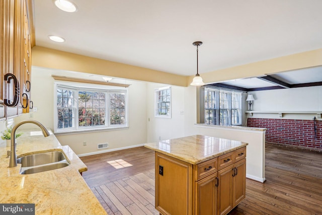 kitchen with dark wood-style floors, visible vents, a wealth of natural light, and a sink