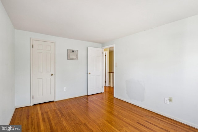 unfurnished bedroom featuring baseboards and wood finished floors