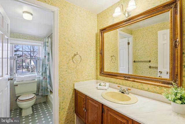 bathroom with wallpapered walls, a shower with shower curtain, toilet, tile patterned floors, and vanity