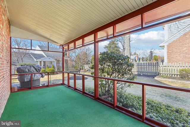 unfurnished sunroom featuring lofted ceiling