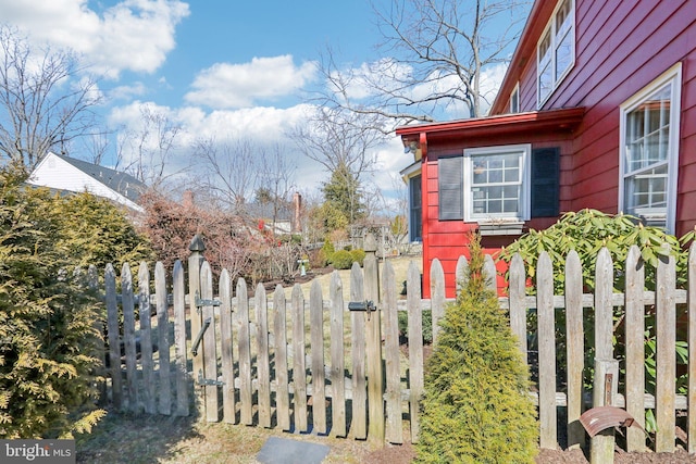 view of side of property with a gate and fence