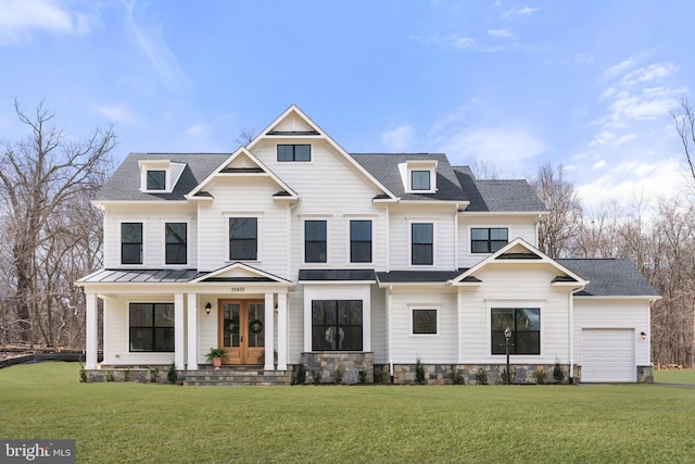 view of front of home featuring a standing seam roof, a shingled roof, a front yard, and french doors