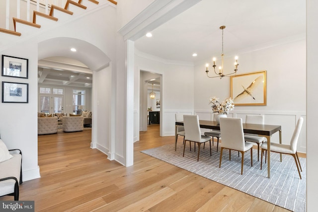 dining area featuring a chandelier, recessed lighting, coffered ceiling, beam ceiling, and light wood finished floors