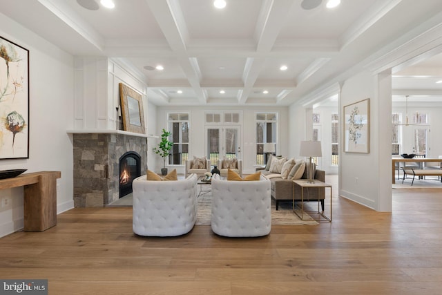 living room featuring light wood-style flooring, recessed lighting, a fireplace, coffered ceiling, and beam ceiling