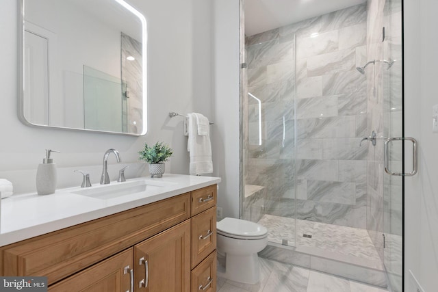 full bath with toilet, marble finish floor, vanity, and a stall shower