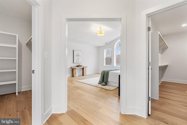 hall featuring baseboards and wood finished floors