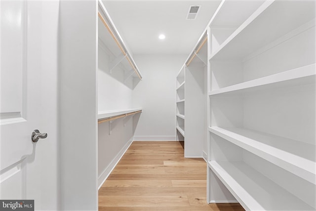 spacious closet featuring light wood finished floors and visible vents