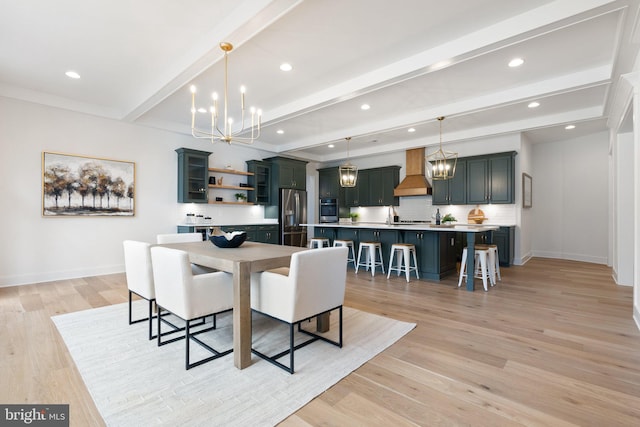 dining room featuring an inviting chandelier, baseboards, light wood finished floors, and beam ceiling