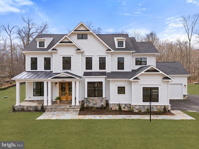 view of front of home with metal roof, a shingled roof, french doors, a standing seam roof, and a front yard