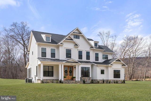 view of front of property featuring roof with shingles, central air condition unit, a standing seam roof, metal roof, and a front lawn