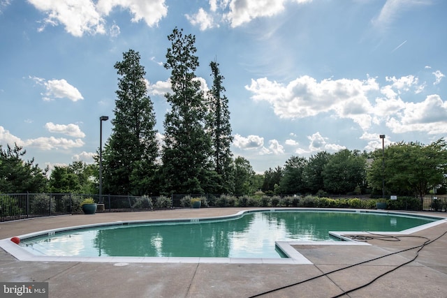 view of swimming pool with fence and a fenced in pool