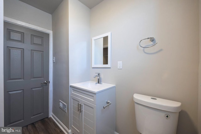 bathroom featuring vanity, toilet, and wood finished floors