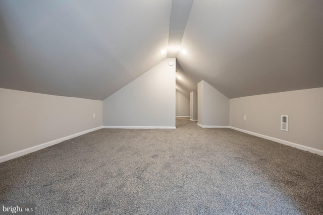 additional living space with lofted ceiling, carpet flooring, baseboards, and visible vents