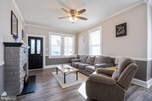 living room featuring ornamental molding, wood finished floors, baseboards, and ceiling fan