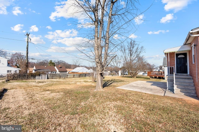 view of yard with a patio area, a residential view, and fence