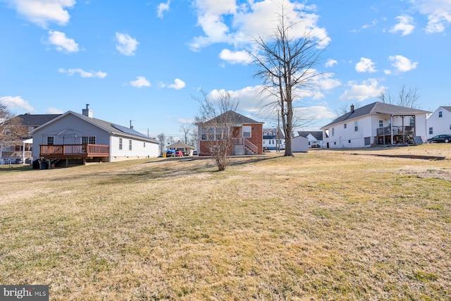 view of yard featuring a deck and a residential view