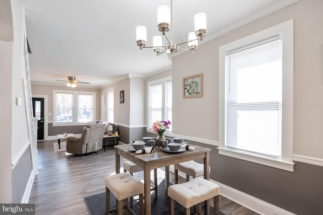 dining room featuring a chandelier, wood finished floors, baseboards, and ornamental molding