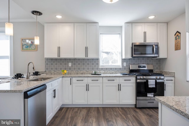 kitchen featuring a sink, tasteful backsplash, appliances with stainless steel finishes, and white cabinets