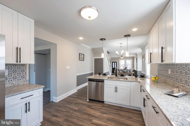 kitchen featuring dark wood-style floors, a peninsula, a sink, white cabinets, and stainless steel dishwasher