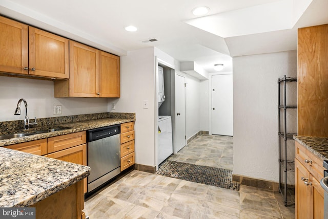 kitchen featuring stone countertops, washer / clothes dryer, stainless steel dishwasher, a sink, and recessed lighting