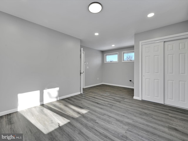 basement with recessed lighting, wood finished floors, and baseboards