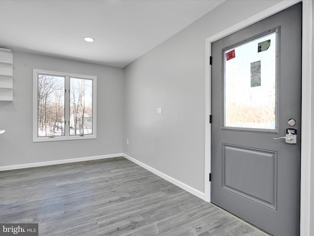 entryway with wood finished floors and baseboards