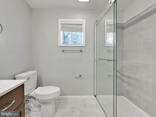 full bathroom with marble finish floor, toilet, a stall shower, vanity, and baseboards