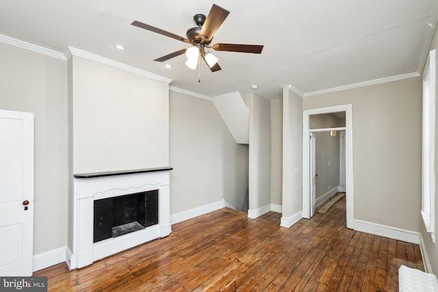 unfurnished living room with a fireplace, crown molding, hardwood / wood-style floors, a ceiling fan, and baseboards