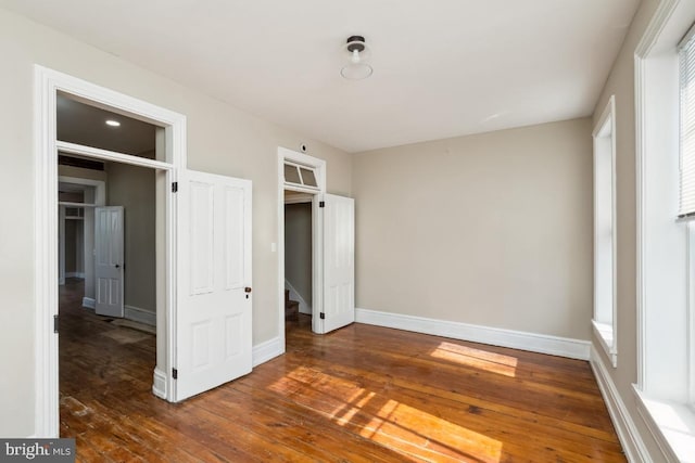 unfurnished bedroom featuring baseboards and hardwood / wood-style floors