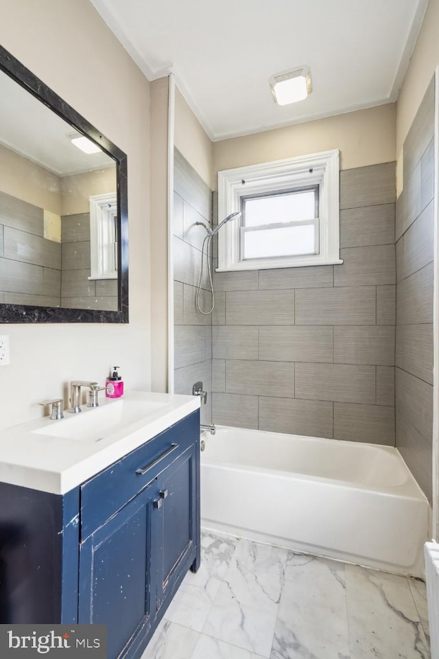 bathroom with marble finish floor, vanity, and bathing tub / shower combination