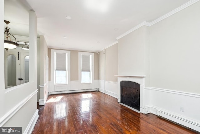 unfurnished living room featuring a wainscoted wall, a fireplace, crown molding, a baseboard radiator, and hardwood / wood-style flooring