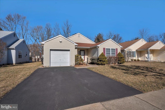 ranch-style home featuring a garage, a front lawn, and aphalt driveway