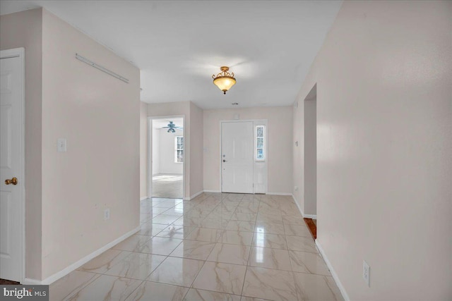 entryway featuring marble finish floor and baseboards