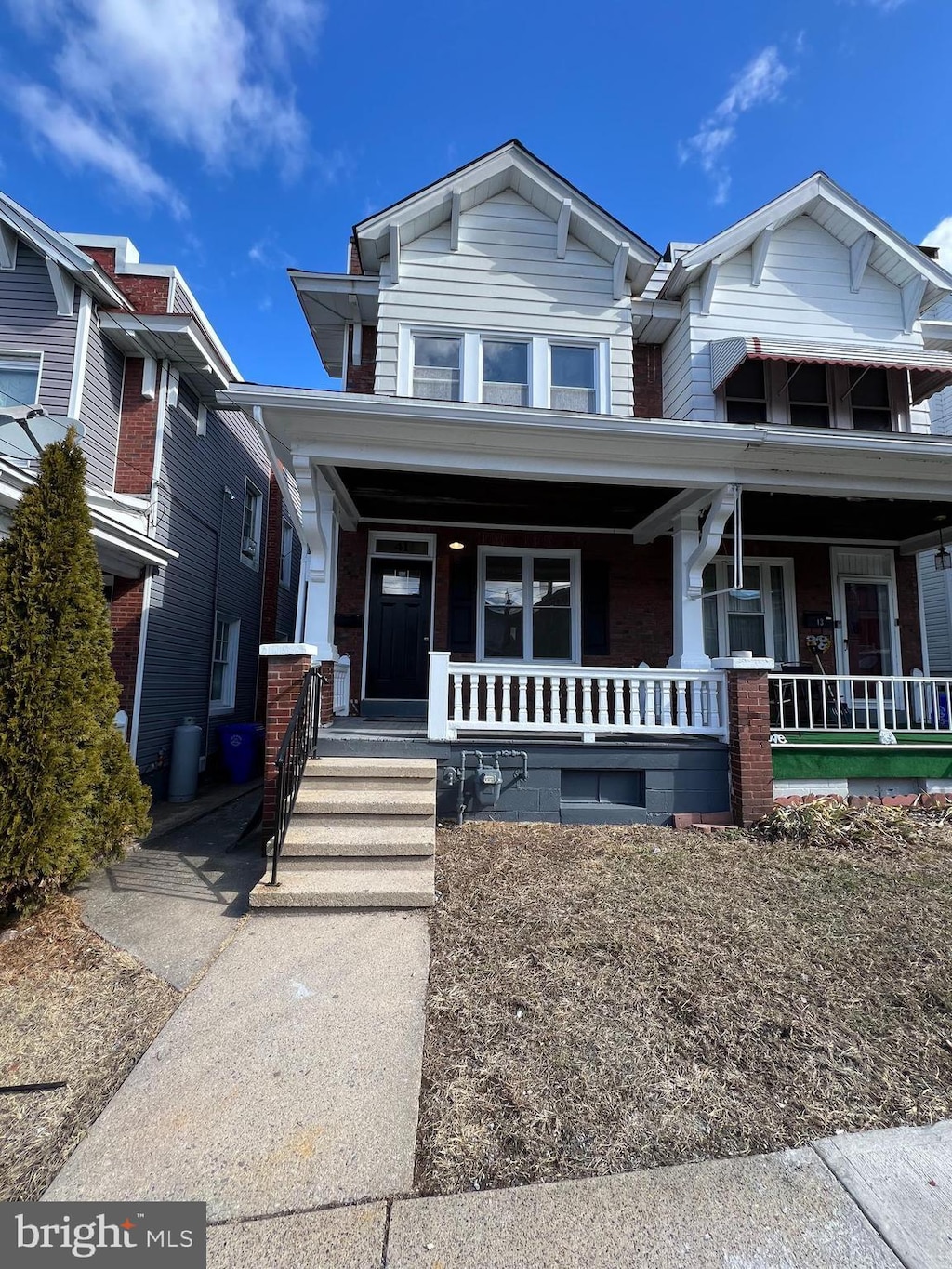 view of front of house featuring covered porch and brick siding