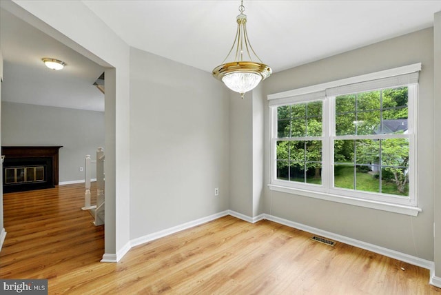 10204 Faire Commons Ct, Burke, VA 22015 - spare room featuring light wood finished floors, baseboards, and a fireplace with flush hearth