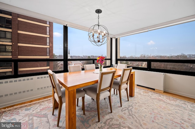 dining room with an inviting chandelier and wood finished floors