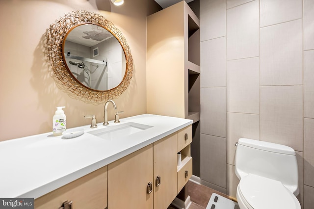 full bathroom featuring vanity, toilet, a shower, and visible vents