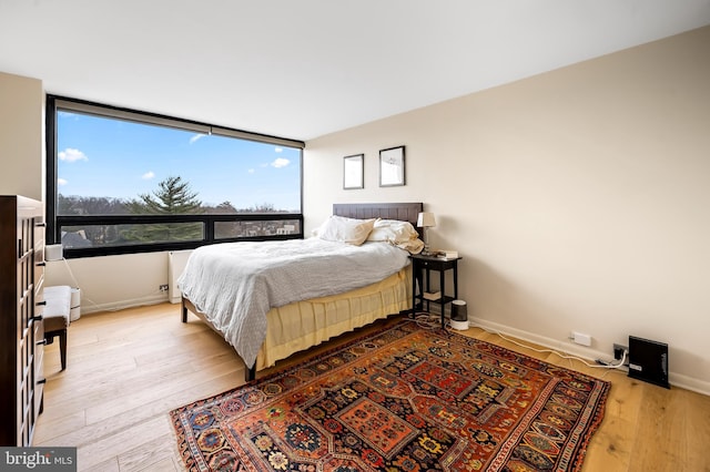 bedroom with baseboards and light wood-style floors