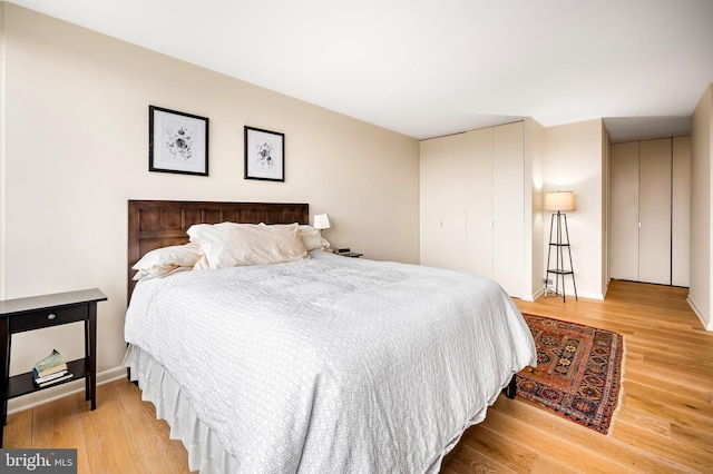 bedroom featuring a closet and light wood finished floors