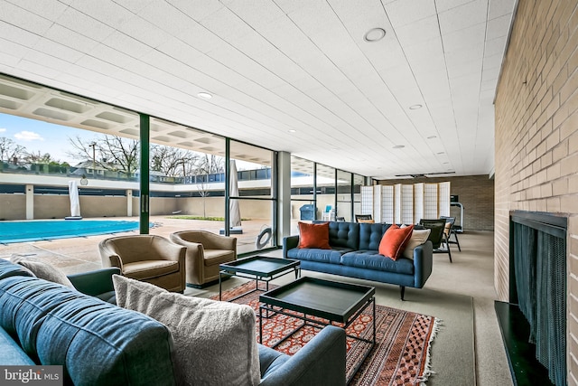 sunroom / solarium with a large fireplace