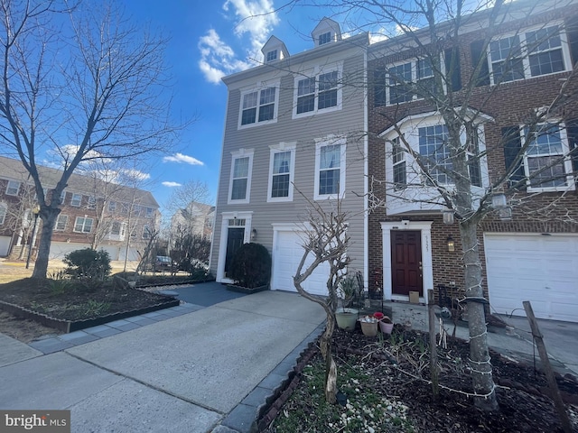 view of front of home featuring concrete driveway and an attached garage