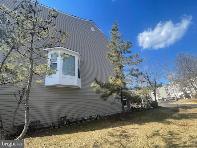 view of side of home featuring a lawn