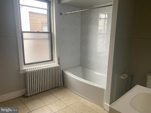 bathroom featuring radiator, tile patterned flooring, and a sink