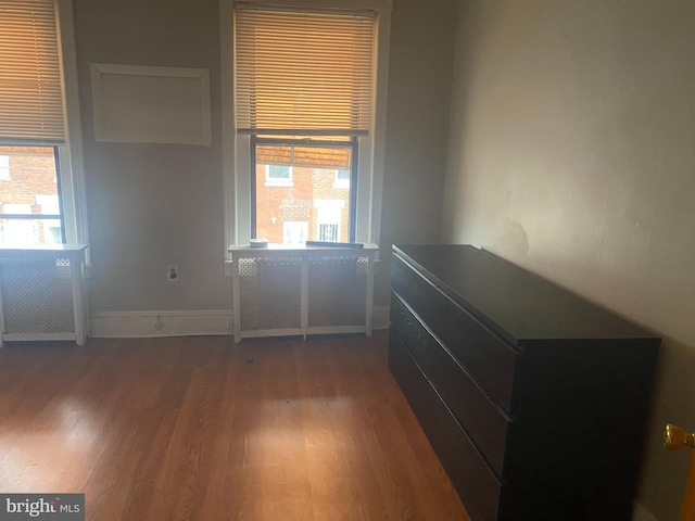 unfurnished bedroom featuring baseboards and wood finished floors