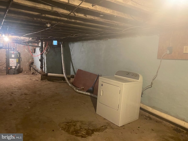 unfinished basement with gas water heater and washer / dryer