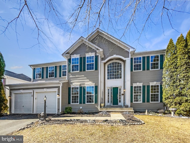 view of front facade with aphalt driveway and an attached garage