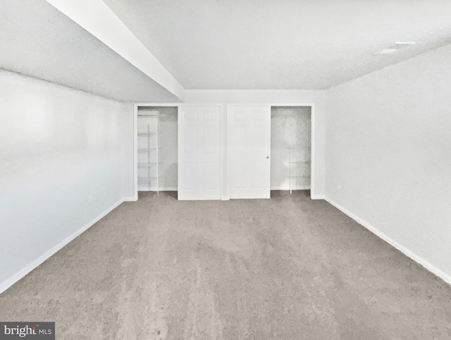 unfurnished bedroom featuring carpet floors and baseboards